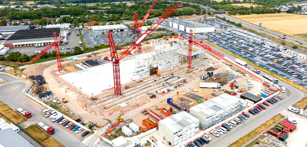 A large construction site with cranes and many support buildings.